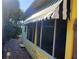 Exterior view of home with striped awning, windows, and brick walkway at 504 79Th Ave, St Pete Beach, FL 33706