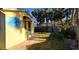 Side view of home with dolphin mural and striped awning at 504 79Th Ave, St Pete Beach, FL 33706
