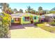 Charming beach house with a carport, teal shutters, and a paver driveway at 504 79Th Ave, St Pete Beach, FL 33706