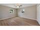 Spacious bedroom with wood-look flooring and ceiling fan at 660 Flamingo Dr, Apollo Beach, FL 33572