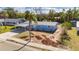 Blue house with a carport and partially landscaped yard at 660 Flamingo Dr, Apollo Beach, FL 33572