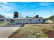 Light blue, single-story home with attached carport and partially landscaped yard at 660 Flamingo Dr, Apollo Beach, FL 33572