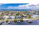 Spectacular aerial view of a waterfront home with a pool, dock, and lush landscaping at 6613 Seabird Way, Apollo Beach, FL 33572