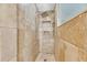 Modern shower with tile walls, dual shower heads, and built-in shelves at 6613 Seabird Way, Apollo Beach, FL 33572
