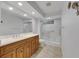Modern bathroom with walk-in shower and wooden vanity at 6613 Seabird Way, Apollo Beach, FL 33572