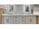 Dual vanities, white cabinets, and a tile backsplash are featured in this updated bathroom at 6613 Seabird Way, Apollo Beach, FL 33572