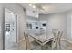 Dining area with glass-top table, view of living room, and access to the kitchen at 6613 Seabird Way, Apollo Beach, FL 33572