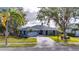 Charming blue two-story home with a paved driveway and landscaped front yard at 6613 Seabird Way, Apollo Beach, FL 33572