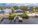 Waterfront home with pool, dock, and view of the waterway and nearby houses at 6613 Seabird Way, Apollo Beach, FL 33572