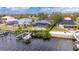 Exterior view of waterfront home with pool and dock, situated alongside neighboring homes at 6613 Seabird Way, Apollo Beach, FL 33572