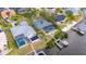 Waterfront home with pool, dock, and solar panels nestled among neighboring houses at 6613 Seabird Way, Apollo Beach, FL 33572