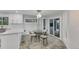 Bright, updated kitchen with white cabinets, quartz countertops, and a round glass-top dining table at 6613 Seabird Way, Apollo Beach, FL 33572