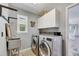 Laundry room with washer, dryer, sink, and cabinets at 6613 Seabird Way, Apollo Beach, FL 33572