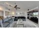 Living room with sectional sofa, ceiling fan, and sliding glass doors to patio at 6613 Seabird Way, Apollo Beach, FL 33572