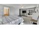 Main bedroom featuring a king-size bed, ceiling fan, and sliding glass doors to the patio at 6613 Seabird Way, Apollo Beach, FL 33572
