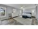 Spacious main bedroom with a king-size bed, ceiling fan, and tile flooring at 6613 Seabird Way, Apollo Beach, FL 33572