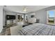Large main bedroom with a king-size bed, ceiling fan, tile flooring, and sliding glass doors at 6613 Seabird Way, Apollo Beach, FL 33572