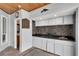 Outdoor kitchen with sink, cabinets, and adjacent bathroom at 6613 Seabird Way, Apollo Beach, FL 33572