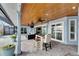Covered patio with seating area, wood ceiling, and pool access at 6613 Seabird Way, Apollo Beach, FL 33572