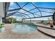 Inviting pool and spa with screened enclosure and waterfront views at 6613 Seabird Way, Apollo Beach, FL 33572