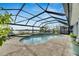 Relaxing pool area with screened enclosure and paver patio at 6613 Seabird Way, Apollo Beach, FL 33572