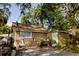 Backyard view featuring a storage shed, outdoor grill, and seating area at 8303 N Mulberry St, Tampa, FL 33604