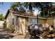 Backyard area with a large grill, firewood, and storage shed at 8303 N Mulberry St, Tampa, FL 33604