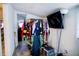 Simple bedroom with clothes rack, TV, and doorway to another room at 8303 N Mulberry St, Tampa, FL 33604