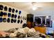 Bedroom with a collection of hats on the wall, bed, and TV at 8303 N Mulberry St, Tampa, FL 33604