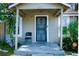 Covered front entry with decorative security door and chairs on the porch at 8303 N Mulberry St, Tampa, FL 33604