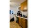 Kitchen with wood cabinets, white countertops, and tile flooring at 8303 N Mulberry St, Tampa, FL 33604