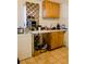 Kitchen with wood cabinets, patterned backsplash, and white countertops at 8303 N Mulberry St, Tampa, FL 33604