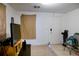Simple living room with a TV, entry door, and tiled floor at 8303 N Mulberry St, Tampa, FL 33604