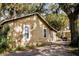 Side exterior view showing a storage shed and outdoor grill at 8303 N Mulberry St, Tampa, FL 33604