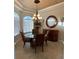 Elegant dining room featuring a chandelier and glass-top table at 8384 Antwerp Cir, Port Charlotte, FL 33981