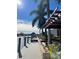 Private dock with a wooden pergola, palm trees, and stunning water views at 8384 Antwerp Cir, Port Charlotte, FL 33981