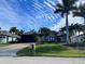 House exterior showcasing a well-maintained lawn and palm trees at 8384 Antwerp Cir, Port Charlotte, FL 33981