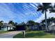 Beautiful home with a landscaped lawn, palm trees, and a two-car garage at 8384 Antwerp Cir, Port Charlotte, FL 33981