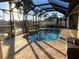 Screened-in pool and patio area with waterfront view at 8384 Antwerp Cir, Port Charlotte, FL 33981