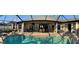 Spacious screened-in pool area with a dining set and lush landscaping at 8384 Antwerp Cir, Port Charlotte, FL 33981