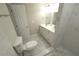 Modern bathroom with white vanity, marble tile, and walk-in shower at 8391 76Th Ave, Seminole, FL 33777