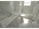 Modern bathroom with marble tile, white vanity, and updated fixtures at 8391 76Th Ave, Seminole, FL 33777