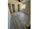 Bedroom featuring wood-look laminate flooring, ceiling fan, and open closet at 8391 76Th Ave, Seminole, FL 33777