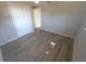 Empty bedroom with closet doors, wood-look laminate floors, and ceiling fan at 8391 76Th Ave, Seminole, FL 33777