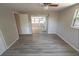 Bedroom with wood-look flooring, ceiling fan, and access to the living area at 8391 76Th Ave, Seminole, FL 33777