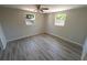 Bright bedroom with multiple windows and wood-look laminate flooring at 8391 76Th Ave, Seminole, FL 33777