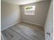 Empty bedroom with neutral gray walls and wood-look laminate floors at 8391 76Th Ave, Seminole, FL 33777