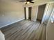 Spacious bedroom with wood-look laminate flooring and open closet at 8391 76Th Ave, Seminole, FL 33777