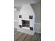White brick fireplace with decorative grate and wood-look flooring at 8391 76Th Ave, Seminole, FL 33777