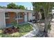 Inviting front yard landscaping leads to a covered porch and front entry at 8391 76Th Ave, Seminole, FL 33777